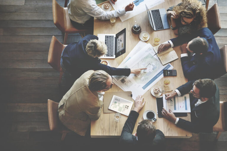 Overhead shot of seven colleagues working at a table